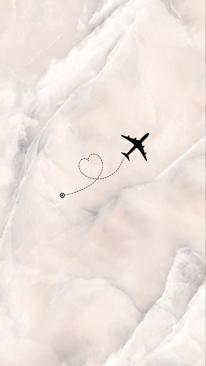 an airplane flying in the sky with a heart on it's tail as seen from above