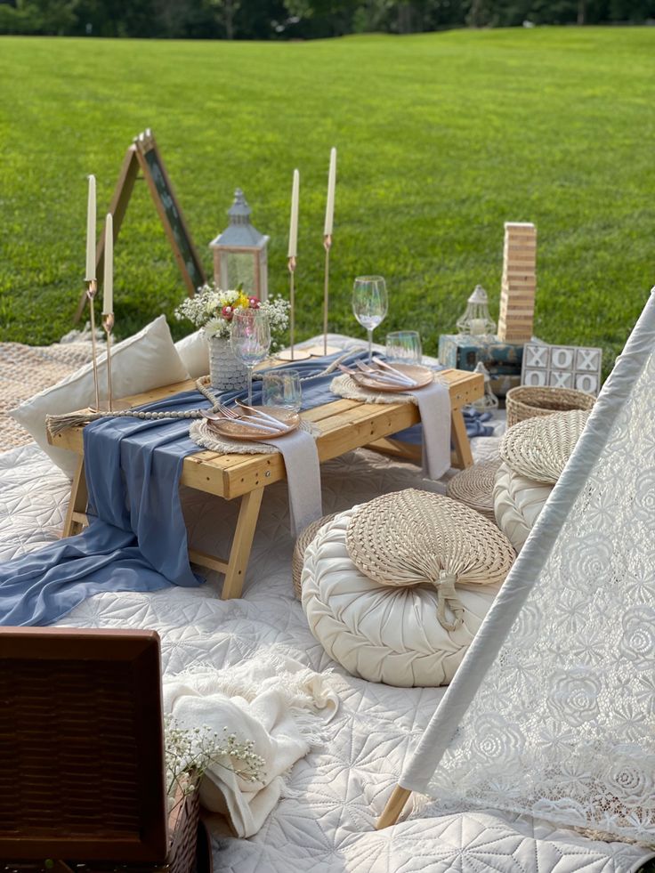 an outdoor picnic setting in the middle of a field