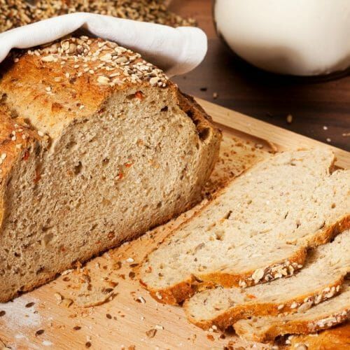 a loaf of bread sitting on top of a wooden cutting board