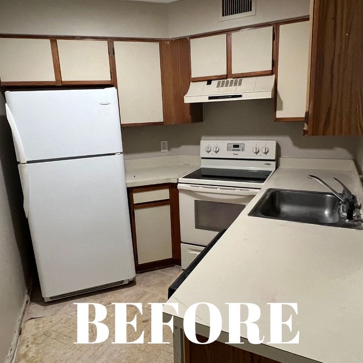 an empty kitchen with white appliances and wood cabinets