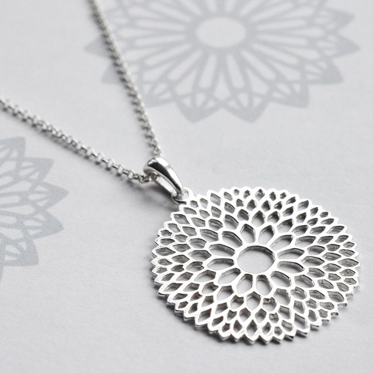 Catch the eye with our stunning Sterling Silver Chrysanthemum Necklace. The exquisite floral pattern of our chrysanthemum jewellery set will be admired by all. In Japanese culture chrysanthemums symbolise celebration and the sun. Japan still holds an annual festival celebrating the flower, it is widely known as the festival of happiness. So why not bring happiness to that someone special in your life? Why not personalise this necklace with the addition of an initial letter charm. All Martha Jackson jewellery comes in a gift box with a small gift card for you to write a message on.  made from: Sterling Silver. Keep clean with an anti tarnish cloth. dimensions: Pendant diameter 3.1cm Add on initial letter charms approximately 1cm. Necklace Length -Short 35-40cm, Standard 40-45cm, 50cm, Long Elegant Round Jewelry With Sunflower Design, Elegant Round Sunflower Design Jewelry, Elegant Round Sunflower Jewelry, Elegant Silver Necklace With Sunflower Design, Elegant Necklace With Sunflower Pendant, Elegant Necklaces With Sunflower Design For Gifts, Elegant Sunflower Design Necklaces As Gift, Elegant Sunflower Design Necklaces For Gift, Elegant Sunflower Pendant Necklace