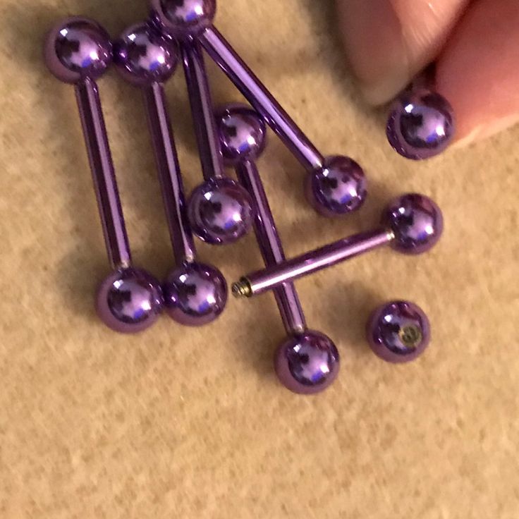 there are many purple balls in the shape of a pyramid on top of a table