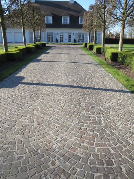 the driveway is made out of cobblestones