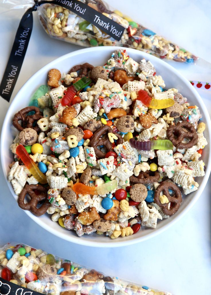 a white bowl filled with cereal and pretzels