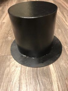 a black top hat is sitting on the floor