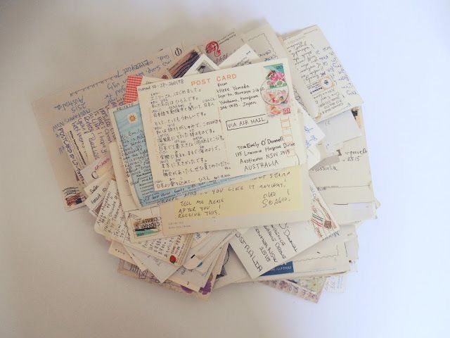 a pile of old papers sitting on top of a white table