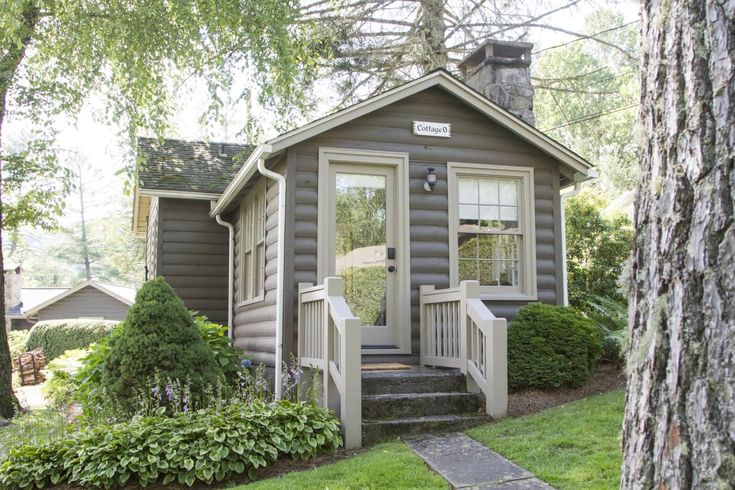 a small house with steps leading to the front door