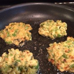 four pieces of food cooking in a frying pan