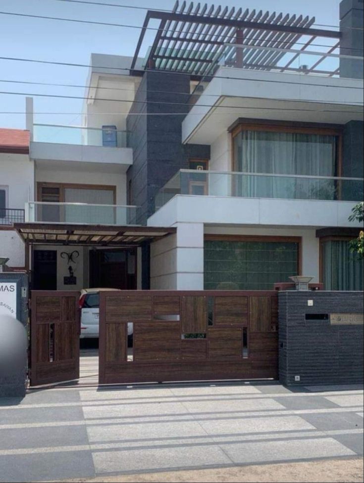 an apartment building with wooden fence and gate