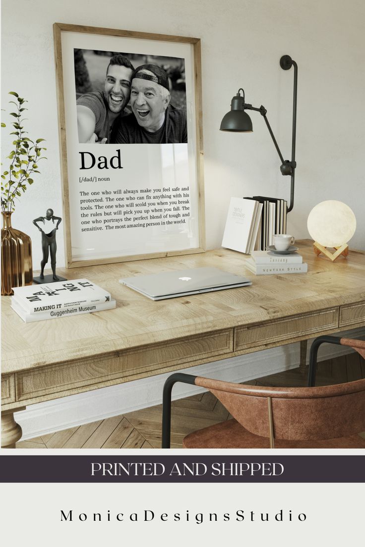 a wooden desk topped with a laptop computer next to a lamp and a framed photo