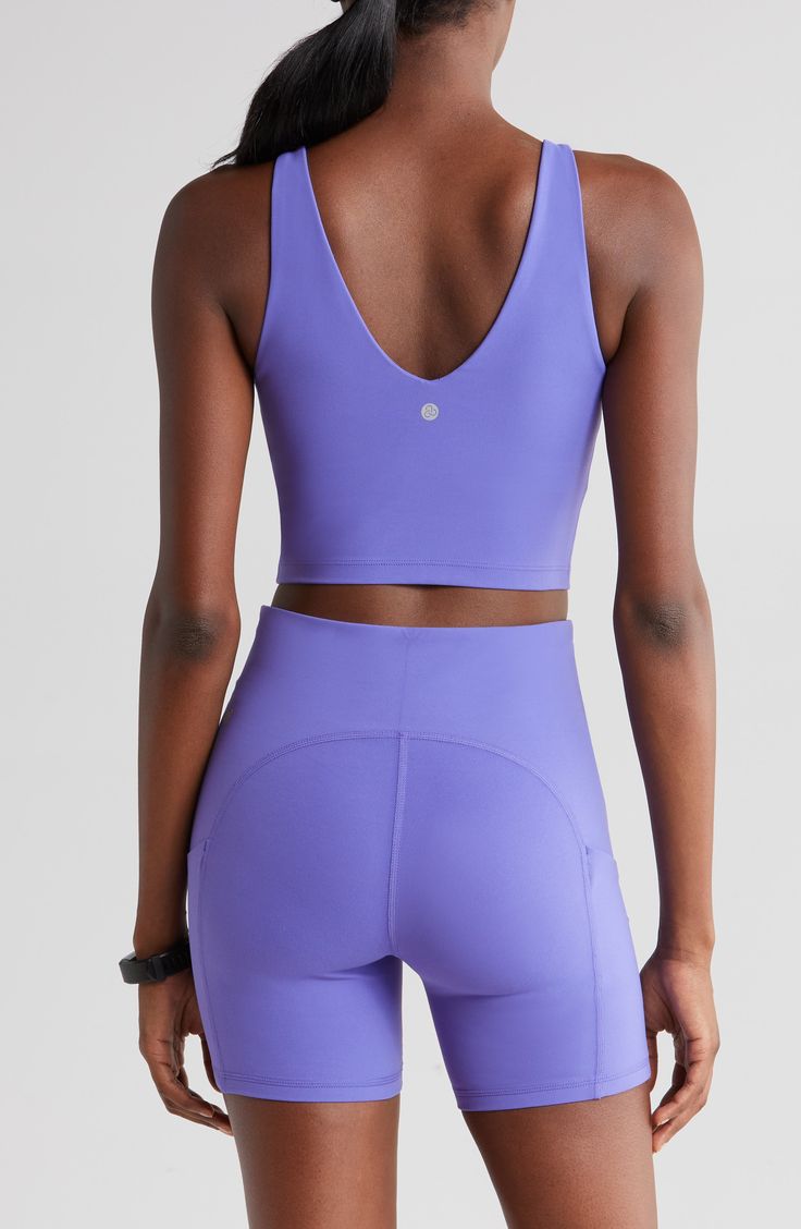 A rounded V-neck and supportive straps shape this cropped tank top with four-way stretch and a built-in shelf-bra making it perfect for your athletic endeavors. 14 1/2" length (size Medium) V-neck Moisture-wicking fabric engineered for dryness and comfort Lined, with removable soft cups 74% nylon, 26% spandex Machine wash, tumble dry Imported Functional Sleeveless Crop Top With Built-in Bra, Athleisure V-neck Crop Top With Built-in Bra, Sleeveless Sports Bra With Built-in Padding For Yoga, Compressive Sleeveless Activewear With Built-in Bra, Sleeveless Yoga Tank Top With Built-in Padding, Yoga Tank Top With Built-in Padding, Solid Cropped Activewear With Built-in Bra, Sleeveless High Stretch Crop Top With Built-in Padding, Sports Tank Crop Top With Built-in Bra