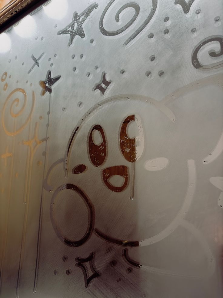 a close up of a glass window with writing on it and an image of a dog's face