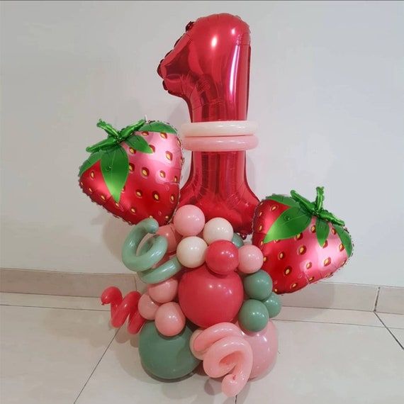 a number one balloon and some balloons in the shape of strawberrys