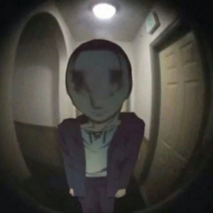 an alien is standing in the middle of a dark tunnel with his hands on his hips