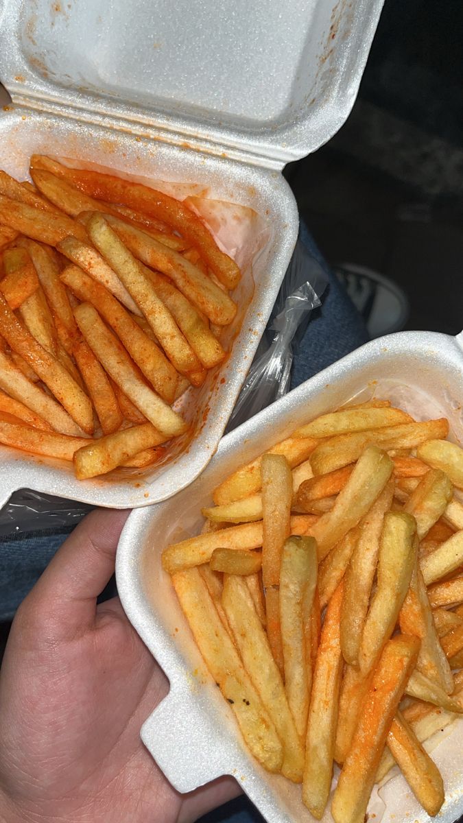 two takeout containers filled with french fries and one holding a container full of them