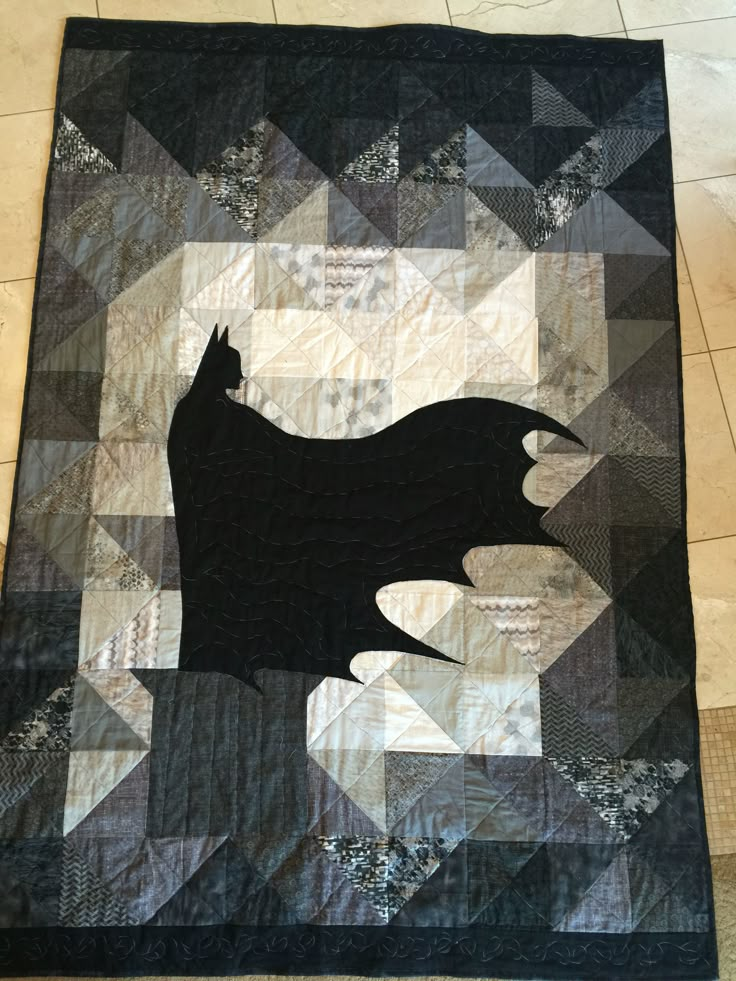 a black and white quilt with a cat on it