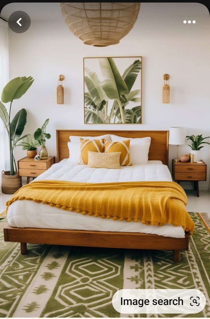 a bed with yellow blankets and pillows in a bedroom