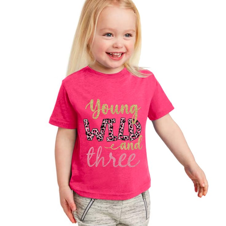 What three year old isn't a little WILD?! Give this fun t-shirt to your birthday girl and listen to them "RAWR" with laughter! Wonderful gift for birthdays and christmas. Uplift any child's wardrobe with a custom kid's t-shirt. This buttery soft short sleeve tee for toddlers is a 100% Airlume combed and ring-spun cotton jersey with a tear-away label for extra comfort. Free shipping included with price. 2T 3T 4T 5-6T Width, in 12.00 13.00 14.00 15.00 Length, in 15.50 16.50 17.50 18.50 Sleeve leng Fun Pink T-shirt For First Birthday, Playful Pink T-shirt For Birthday, Playful Pink T-shirt For Party, Pink Playful T-shirt For Parties, 3rd Birthday Shirt, Young Wild And Three, Birthday Tshirts, Third Birthday, Soft Shorts