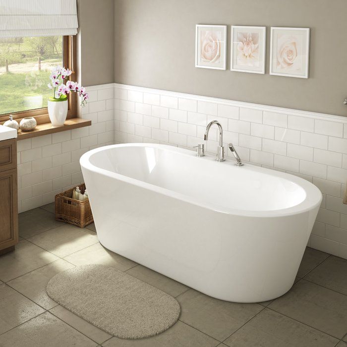 a white bath tub sitting in a bathroom next to a sink