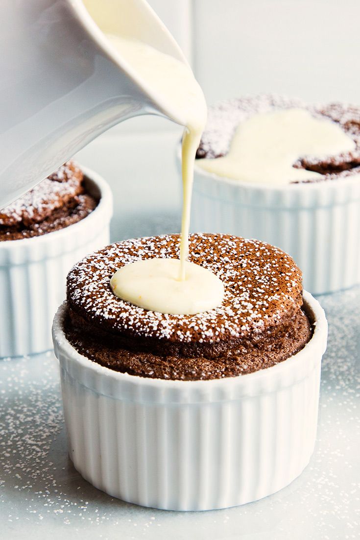 chocolate cupcakes with cream being drizzled on top