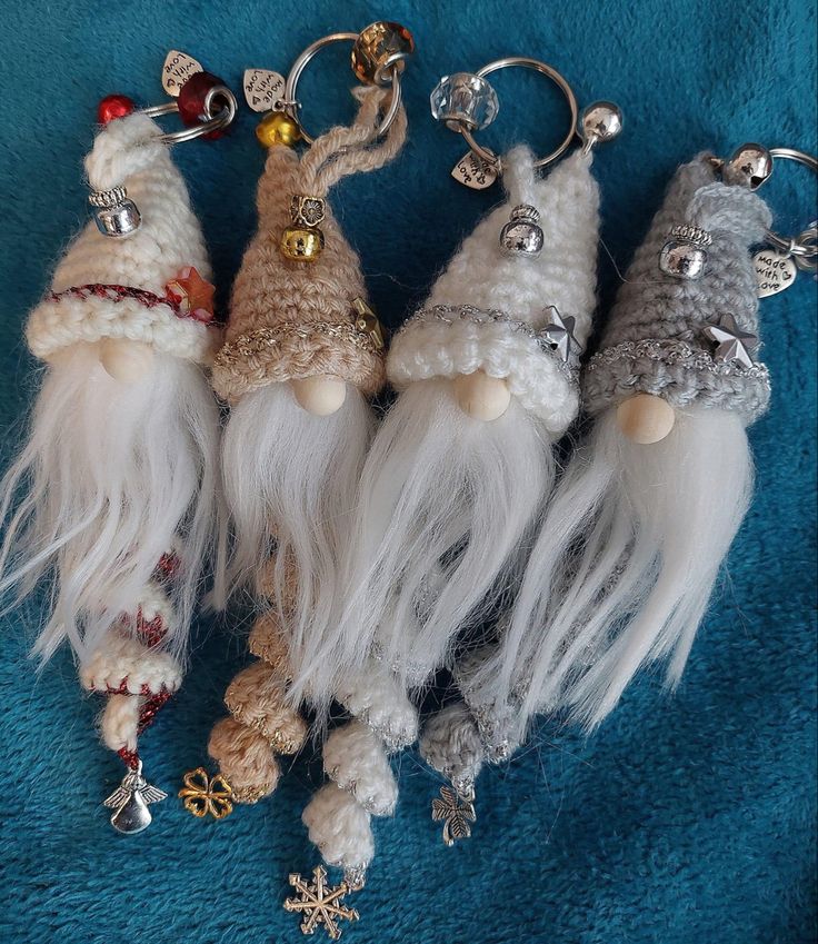 four crocheted gnome keychains with bells and snowflakes