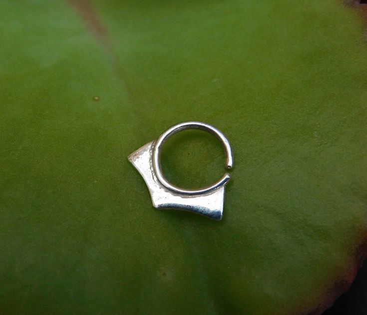 Geometric silver hoop ring- tribal boho piercing ~ Can be used as a nose ring / septum / tragus / single earring / helix / lip ring ~ Size of the nose ring: Inner diameter : 1/4, 5/16 or 3/8 inch (7,8 or 9 mm) Wire gauge : 24,22,20,18 or 16 (0.5, 0.6, 0.8, 1 or 1.2 mm) ~ For larger sizes and special requests please contact me through the' Request custom order' bar. ~To open the ring -gently twist the ends sideways, slip into the hole and then gently twist the ends back for a continuous hoop. ~ Y Adjustable Silver Toe Ring Piercings, Tiny Silver Minimalist Septum Ring, Dainty Tiny Silver Septum Ring, Dainty Silver Small Septum Ring, Small Silver Dainty Septum Ring, Handmade Minimalist Silver Septum Ring, Silver Open Ring Septum As Gift, Silver Open Ring Septum Gift, Handmade Silver Minimalist Nose Rings