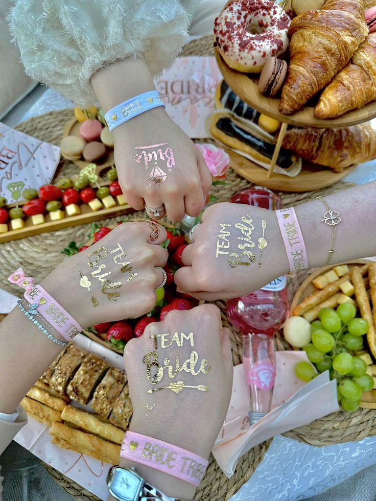 two bride and groom's hands painted with gold on their wedding day fingernails