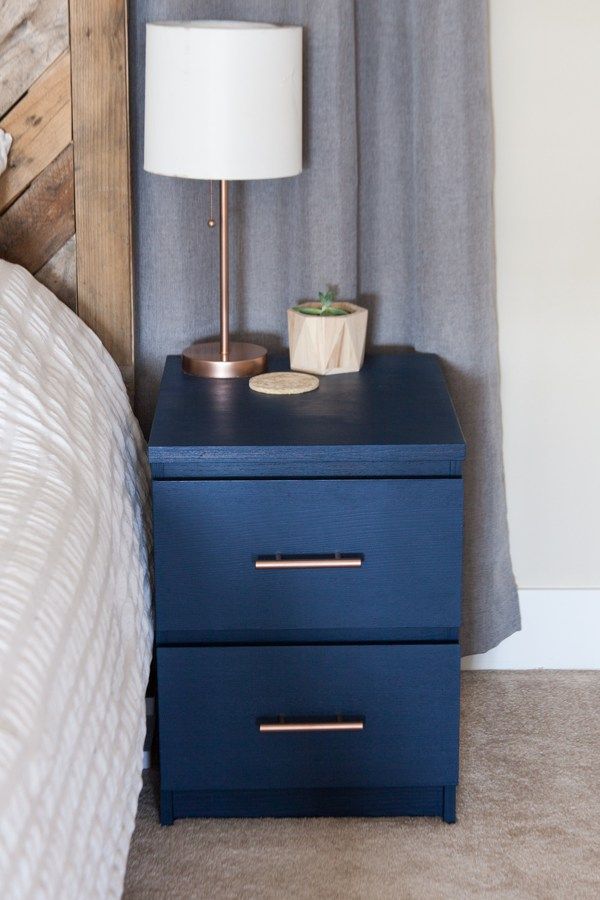 a blue nightstand with a white lamp on top