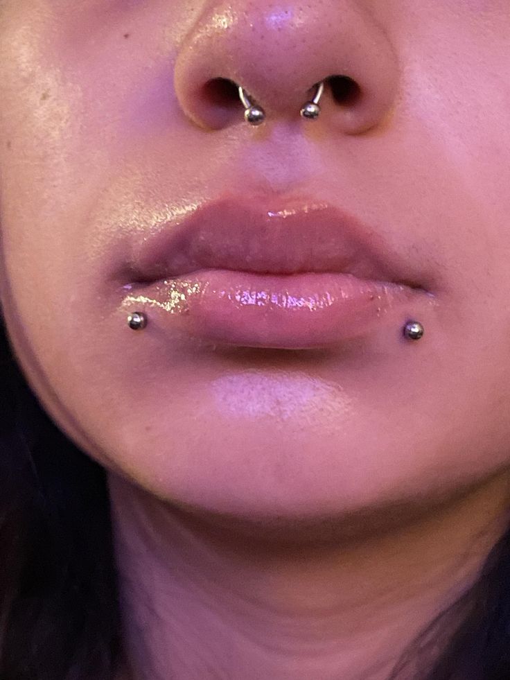 a woman with piercings on her nose