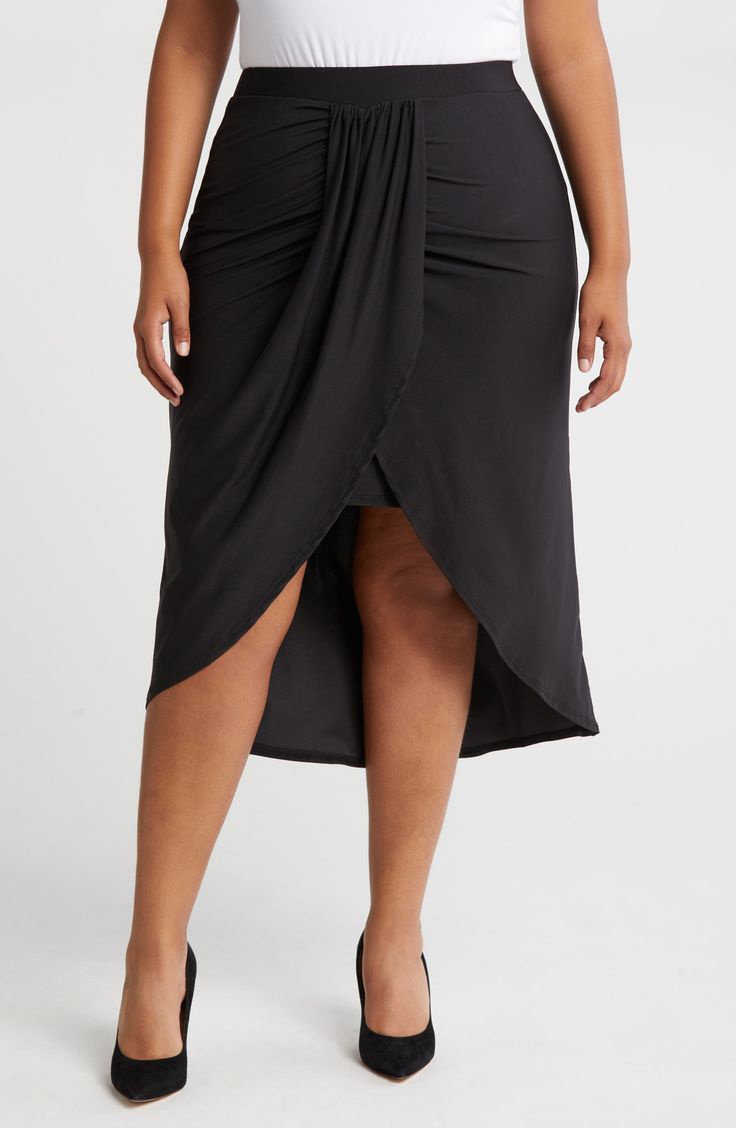 Soft, stretchy jersey adds a comfortable touch to this curve-hugging wrap skirt designed with an elegant draped design at the front. Elastic waist Lined 95% rayon, 5% spandex Machine wash, tumble dry Imported Draped Lined Skirt, Relaxed Ruched Draped Skirt, Ruched Draped Flowy Skirt, Draped Flowy Ruched Bottoms, Black Flowy Draped Skirt, Black Draped Flowy Skirt, Stretch Draped Bottoms For Night Out, Elegant Bottoms With Asymmetrical Hem For Date Night, Stretch Draped Skirt For Night Out