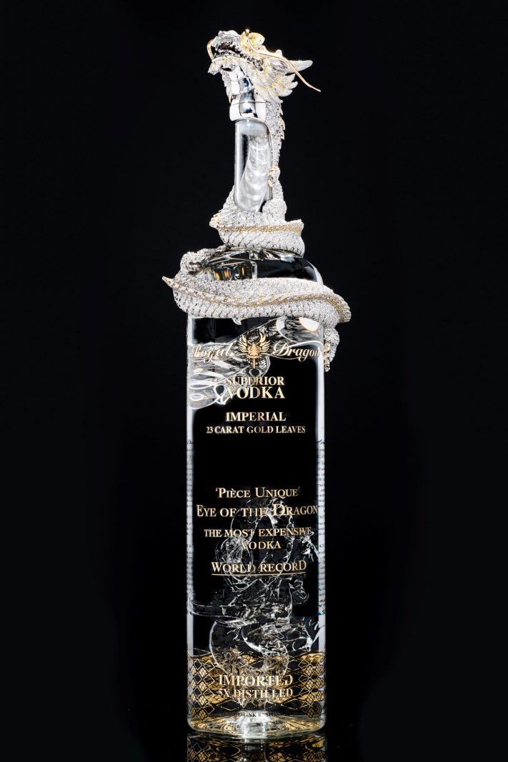 a glass bottle with a statue on top