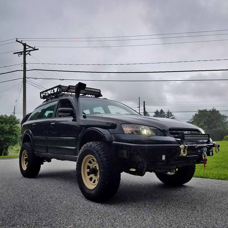 a black suv parked on the side of a road