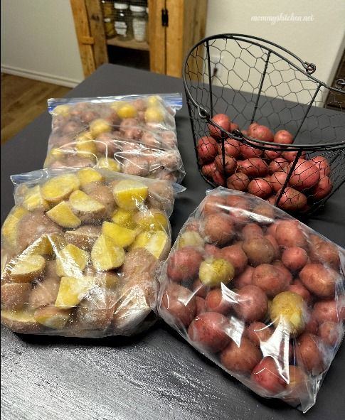 three bags of potatoes sitting on top of a table