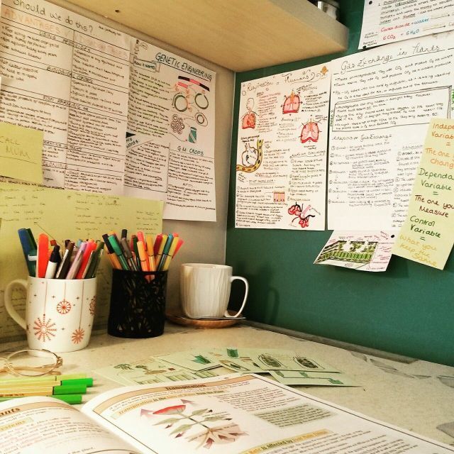 there are many papers and pencils on the counter in this office area, with coffee cups next to them