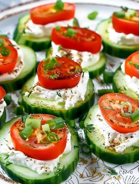 cucumbers with tomatoes and cream cheese on a plate