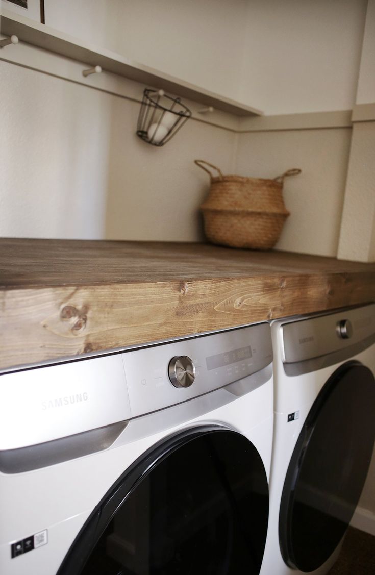 a washer and dryer sitting next to each other in a room with white walls