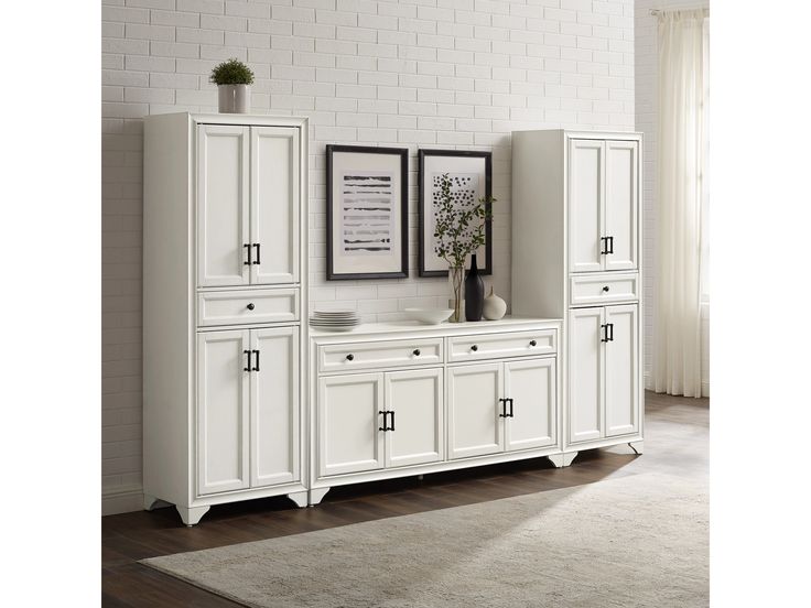 a large white cabinet with two doors and drawers