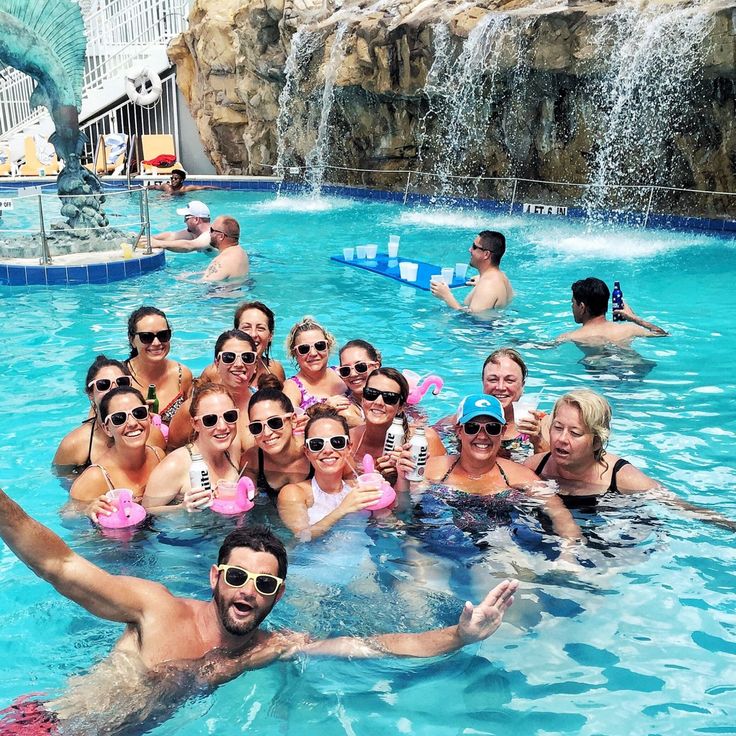 a group of people in the pool posing for a photo