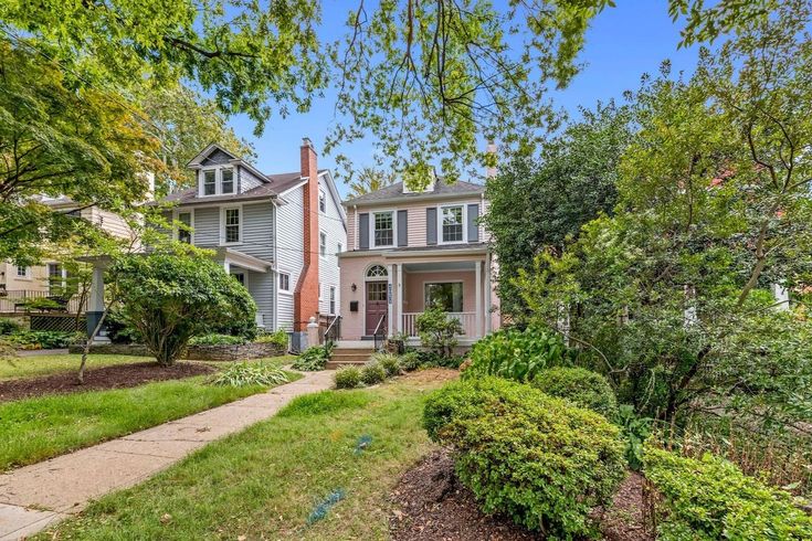 a house with trees and bushes in front of it