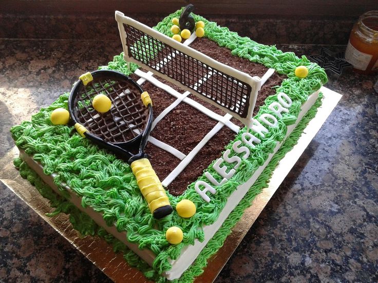 a tennis themed cake is sitting on a table