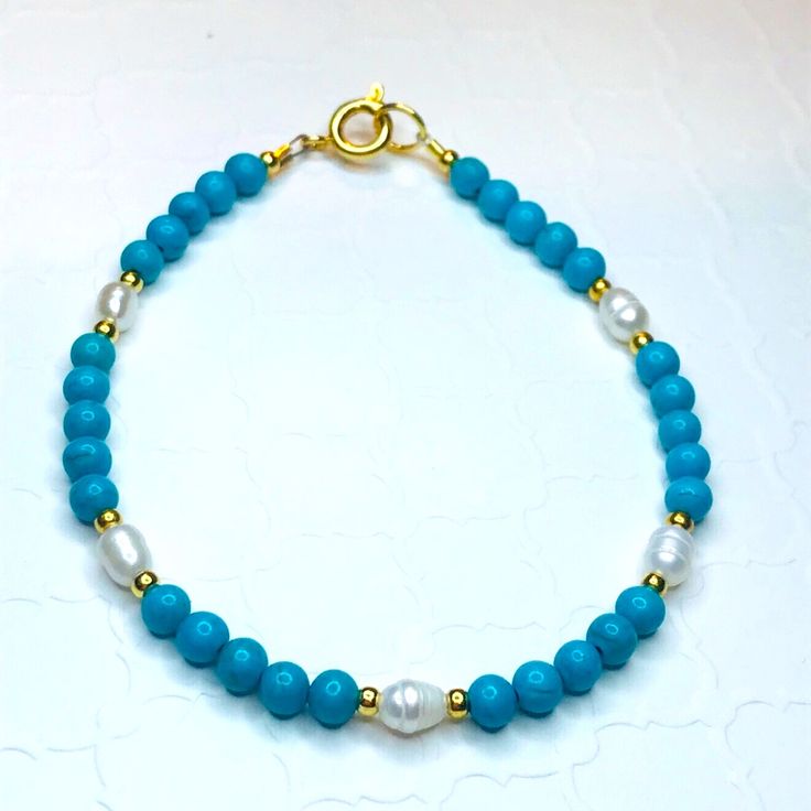 Pretty Simply Stated Piece Made With Magnesite, Fresh Water Pearls And 14k Gold Filled Beads. Made With A Gold Spring Ring Clasp. Blue Pearl Bracelet With Gemstone Beads For Gift, Blue Pearl Bracelet With Gemstone Beads As A Gift, Handmade Elegant Blue Pearl Bracelet, Elegant Handmade Blue Pearl Bracelet, Elegant Turquoise Pearl Bracelet For Gift, Turquoise Single Strand Bracelet Gift, Turquoise Single Strand Bracelet As Gift, Turquoise Single Strand Bracelet For Gift, Elegant Single Strand Turquoise Bracelet