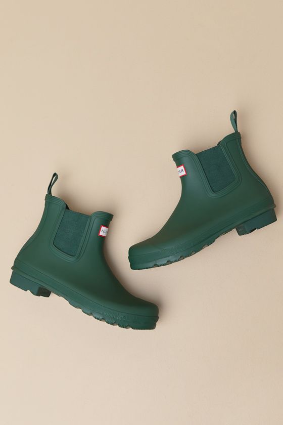 Romanticize rainy days with every step in the Hunter Original Hunter Green Chelsea Rain Boots! These matte rubber rain boots feature a rounded upper that rises to an ankle-high shaft with elastic gussets at the instep and outstep. The slip-on design features a pull tab and a ribbed-textured detail at the back, all atop a sturdy low-block heel. Logo tag at the front. Available in whole sizes only. 0. 75" rubber heel. Lightly cushioned insole. Rubber sole has nonskid markings. Man made materials. Rain Boot Outfit, Hunter Boots Outfit, Short Rain Boots, Chelsea Rain Boots, Oc Inspo, The Hunter, Low Block Heels, Logo Tag, Rubber Heels