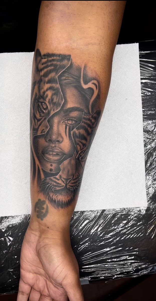 a person with a tiger tattoo on their arm