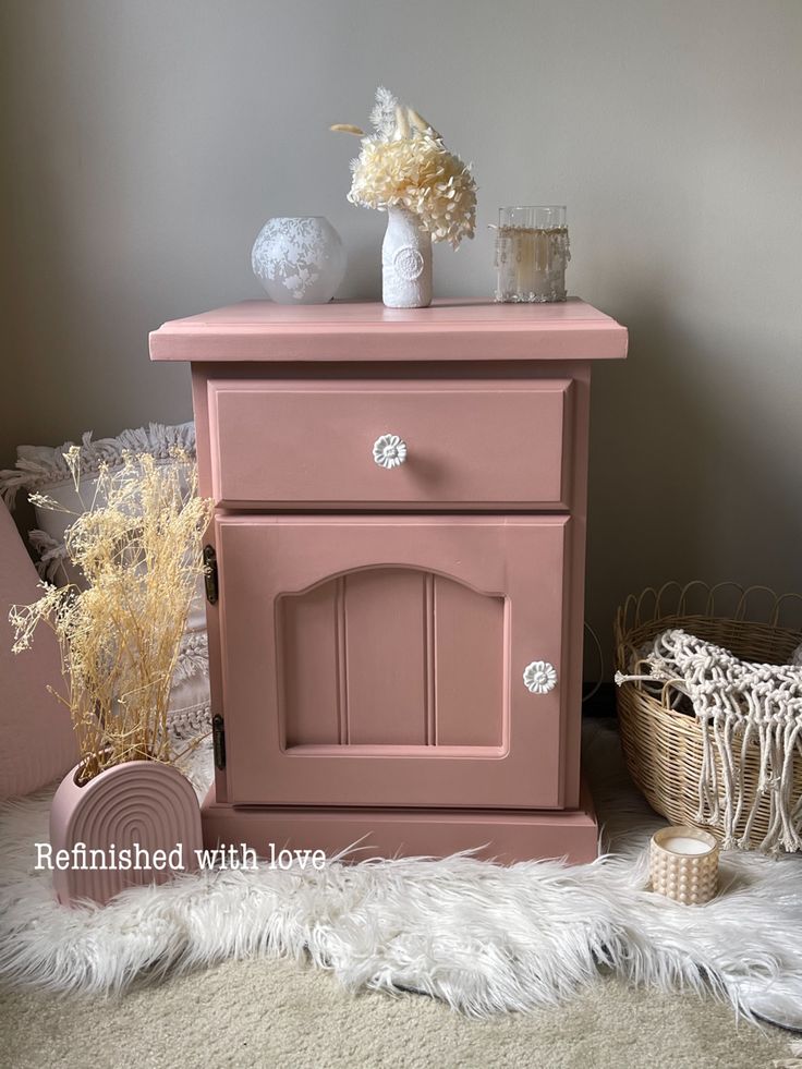 a pink dresser sitting on top of a white rug