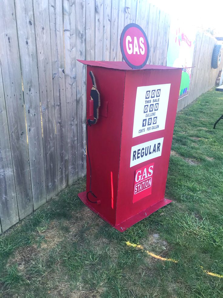 an old fashioned gas pump sitting in the grass