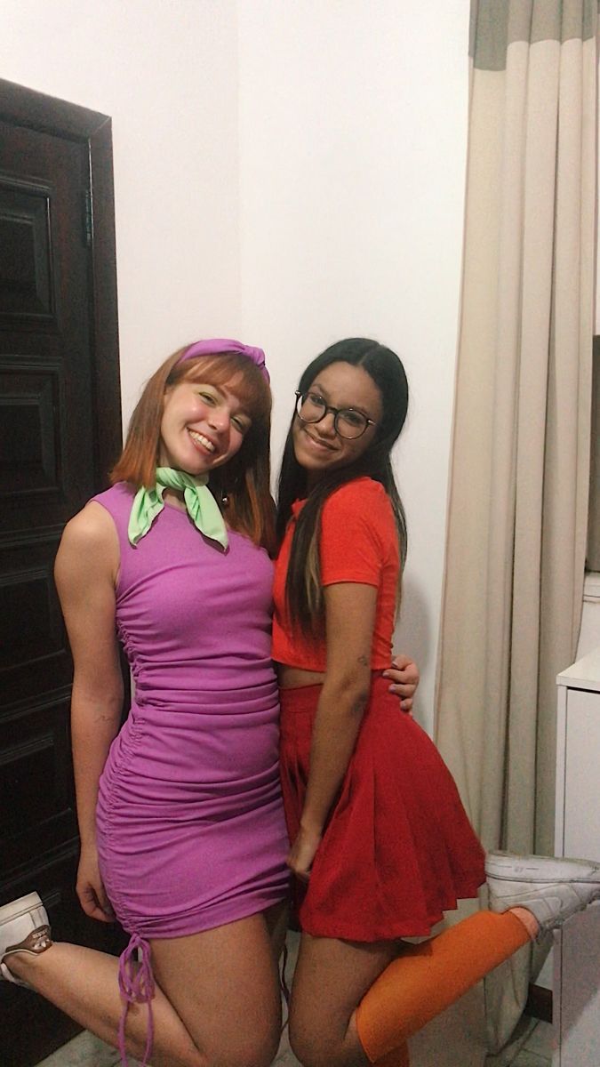 two women in short dresses posing for the camera