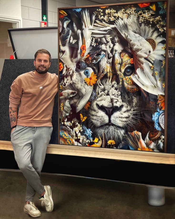 a man standing next to a large painting