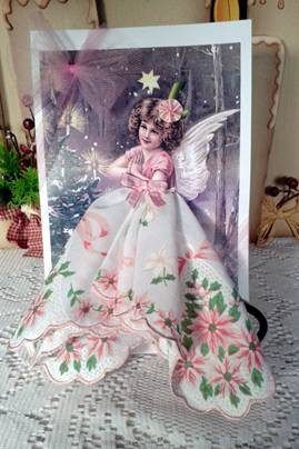 a card with an angel on it sitting on a table