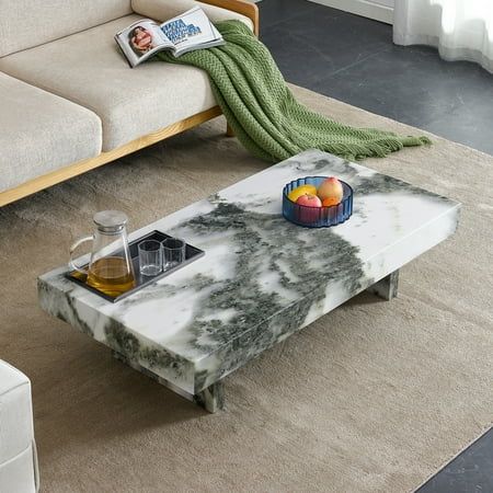 a marble coffee table sitting on top of a rug