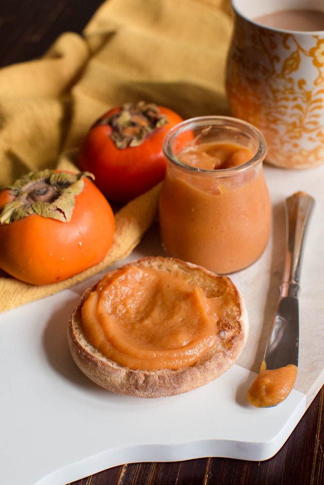 some food is sitting on a plate with a cup of coffee next to it and two tomatoes in the background